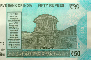 A new banknote of India with a denomination of 50 rupees. Indian currency. The other side, Hampi's...