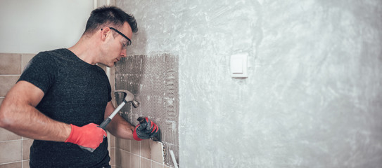 Men renovating kitchen tiles