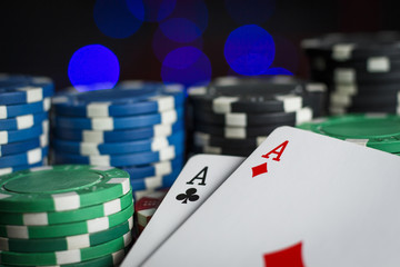 Obraz premium A lot of poker chips with a pair of aces on the table