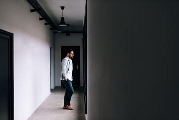 Fototapeta premium Handsome businessman looking at the window.