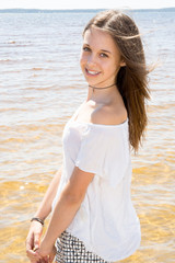 Fototapeta na wymiar Outdoor summer portrait of young pretty girl to the ocean at tropical beach enjoy freedom and fresh air