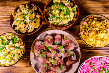 Different festive dishes on a wooden table. Top view