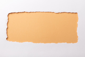 Ripped white paper with colored background with space for text