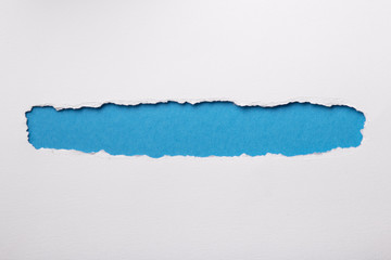 Ripped white paper with colored background with space for text
