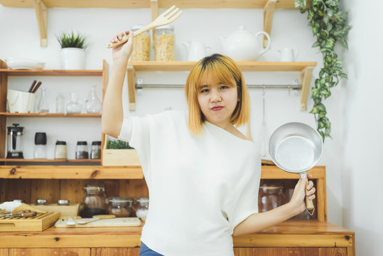 Asian woman making healthy food standing happy smiling in kitchen preparing salad. Beautiful cheerful Asian young woman at home. Healthy food dieting and healthy lifestyle cooking at home Concept.