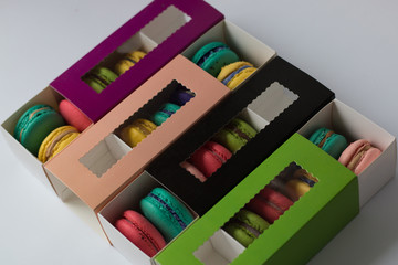 mix of macaroons in colored boxes