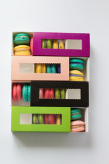 mix of macaroons in colored boxes