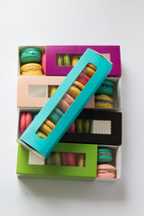 mix of macaroons in colored boxes