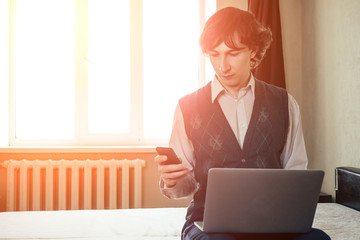 multitasking man using phone, laptop