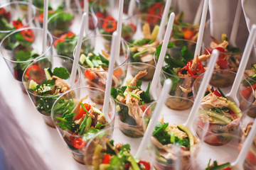 Beautifully decorated catering banquet table with different food snacks and appetizers
