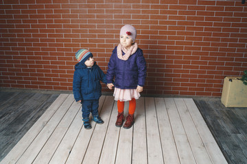 Girl Holding Brother's Hand