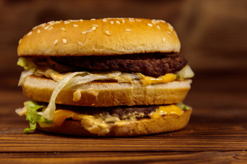 Delicious big hamburger on wooden table