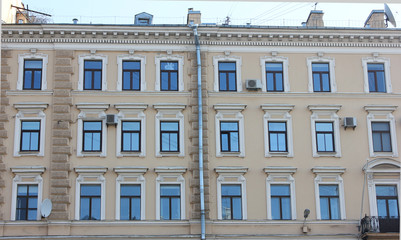 Classical Building Facade Architecture of Old Historical House with Soft Beige Colored Walls. Exterior Design and Details of Apartment Building Front View. Minimalist Style European Architecture.