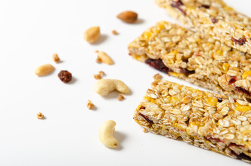 Energy bar of muesli with nuts, berries and oat flakes on white background. Healthy food, granola for breakfast. Diet