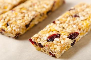 Granola bar with nuts, berries and oat flakes on a white background. Healthy food. Diet and vegetarian dish
