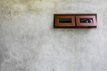 Small wood windows on cement congret wall