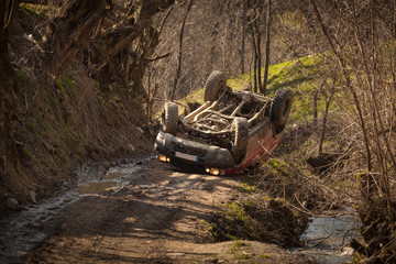 Offroad rollover accident, car flipped on mountain road - obrazy, fototapety, plakaty