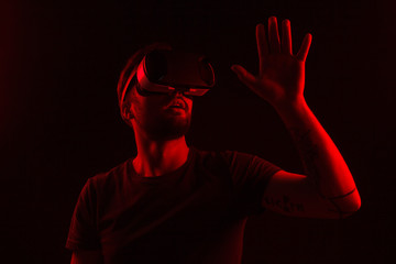 Excited man touching air in VR goggles