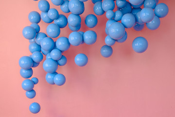 A large number of colorful balloons in a pink room