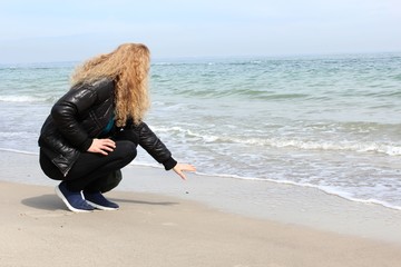 Beautiful woman catching waves on a beach