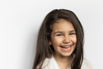 Portrait of happy cute brunette child girl with long hear. 