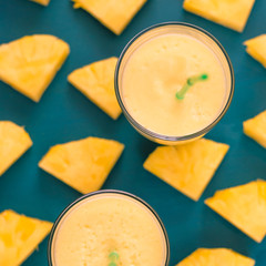 pineapple juice in a glass and pineapple fruits around