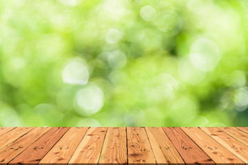 Wooden table on and blur nature tree green background for spring or summer concept.