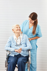 Alte Seniorin im Rollstuhl mit Pflegedienst Frau