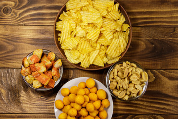 Mix of snacks for beer on wooden table
