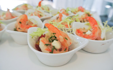 Nice appetizer, fusion food, tasty salad with shrimp served in small white bowl