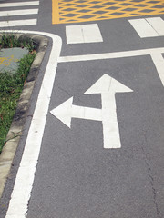 Arrow signs as road markings on a street