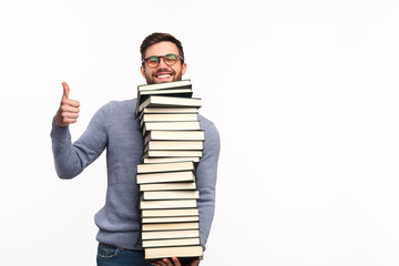 Content man with books holding thumb up