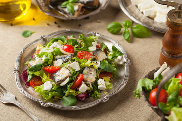 A delicious salad with sardines and feta cheese.