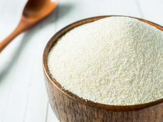 Semolina in a wooden bowl on a light background