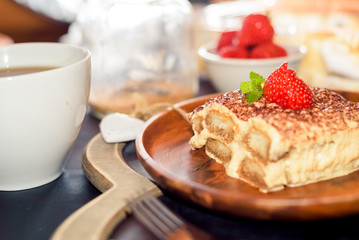 Tiramisu - Classical Dessert Garnished with Strawberry and Mint