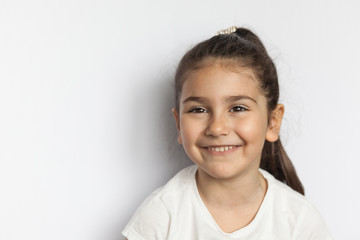 Portrait of happy cute brunette child  girl with long hear isolated on white background