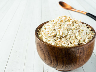 Grits in a wooden bowl on a light background