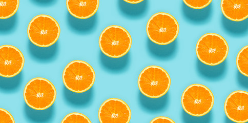 Fototapeta Fresh orange halves on a blue background obraz