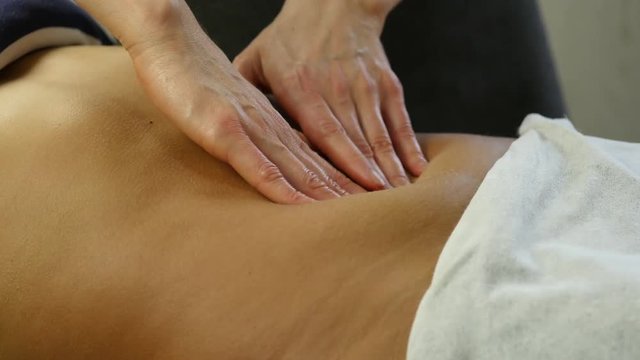 close-up hands of masseur. abdominal massage, massage of internal organs. 4K