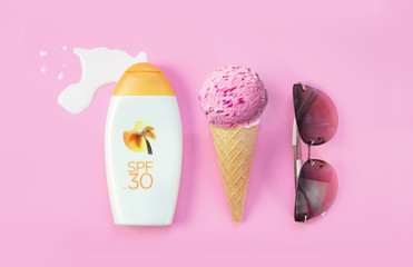 Creative layout concept for summer holidays. A set of sunglasses, ice cream cone and bottles of...