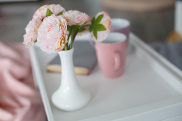 breakfast table in the bed.
cup of tea in the morning in bed.
pink cup with a heart
