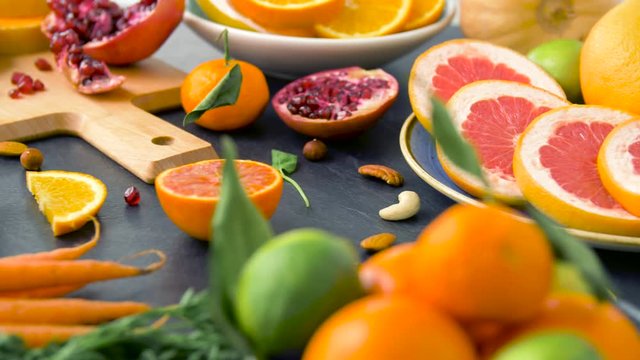 food, healthy eating and vegetarian concept - close up of fruits, nuts and vegetables on table top