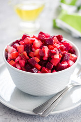Healthy beetroot salad in a bowl on light concrete background. Selective focus, copy space.