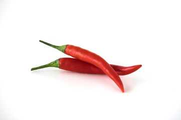 Two red hot chili pepper isolated on the white background. Selective focus.
