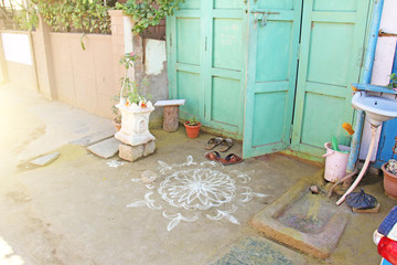 White mandala is painted on sand or on the ground. India, the village of Hampi