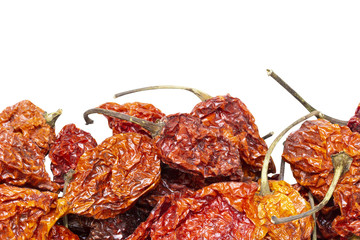 dried carolina reaper peppers isolated on white background