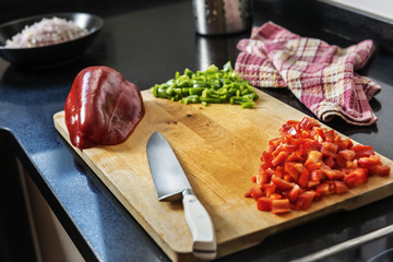 wooden table with chopped pepper and a knife