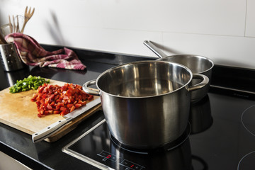 cooking pots with pepper in a wooden table