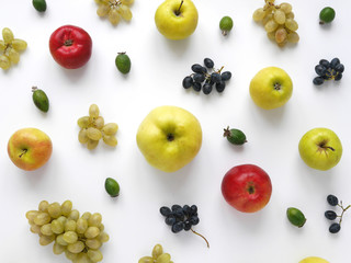 Autumn concept. grapes, red and green apples on a white background. Pattern of fresh composition of fresh vegetables and fruits. Top view, flat lay.