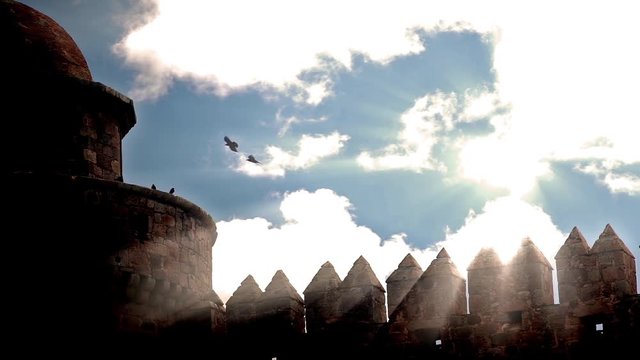 Ravens silhouetted by sun beams soaring over castle walls in slow motion, Calahorra Spain.mov